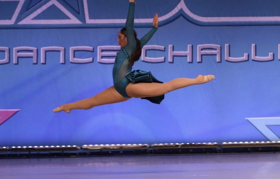 Dancer mid-leap on stage